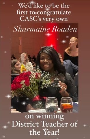 Шармина Руден тепло улыбается, элегантно одета, фон с мягким фокусом подчеркивает ее черты.